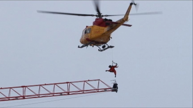 VIDEO: In Ontario, one man hung on as he waited for more than an hour to be rescued by helicopter.