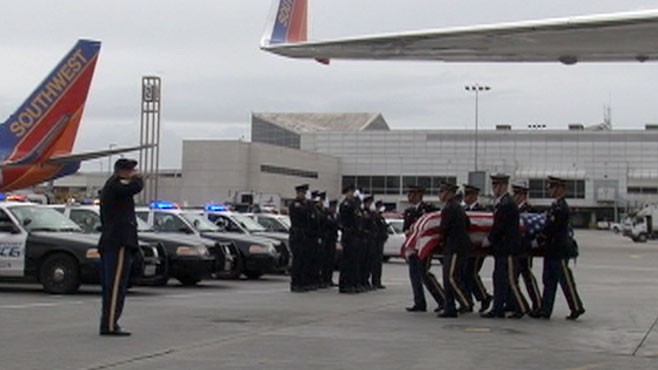 VIDEO: Police officer leads honor guards for war dead arriving at LAX.