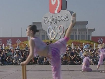 Girl infront of Olympics sign