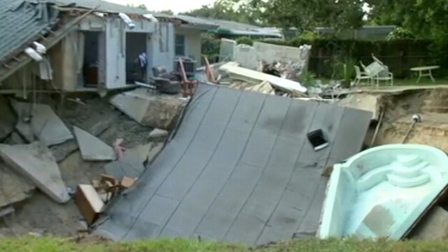 VIDEO: After hearing a rumbling roar at daybreak in Dunedin, Fla., one home collapsed into the earth.