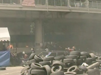 VIDEO: Thai troops stormed anti-government protest camps and opened fire.