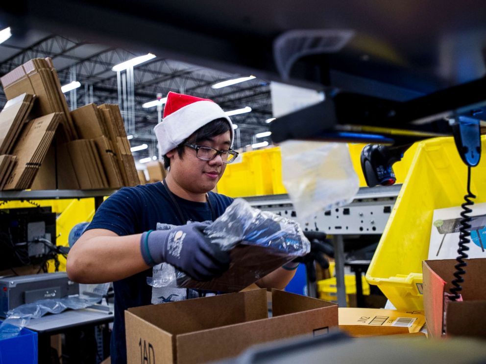 PHOTO: An Amazon.com Inc. employee loads merchandise into a box at the companys fulfillment center ahead of Cyber Monday in Tracy, Calif., Nov. 30, 2014.