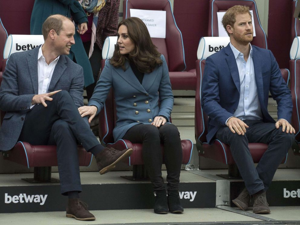 PHOTO: Britains Prince William, Duke of Cambridge and Britains Catherine, Duchess of Cambridge share a light moment as Britains Prince Harry looks on during their visit to attend the graduation ceremony, in east London, Oct. 18, 2017. 