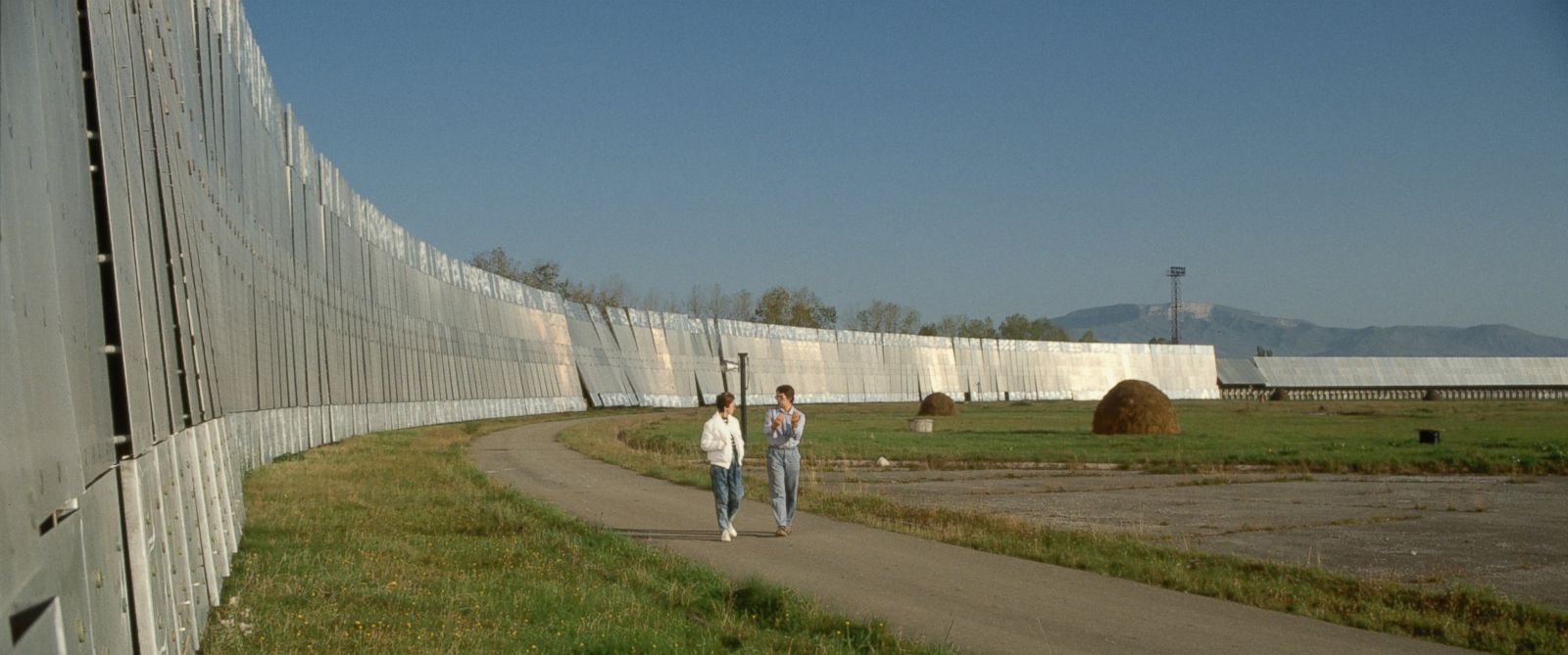 PHOTO: Olga Verkina, left, and Valentin Lipovetsky walk past the reflector antennas of the RATAN-600 radio telescope near Zelenchukskaya, Russia.