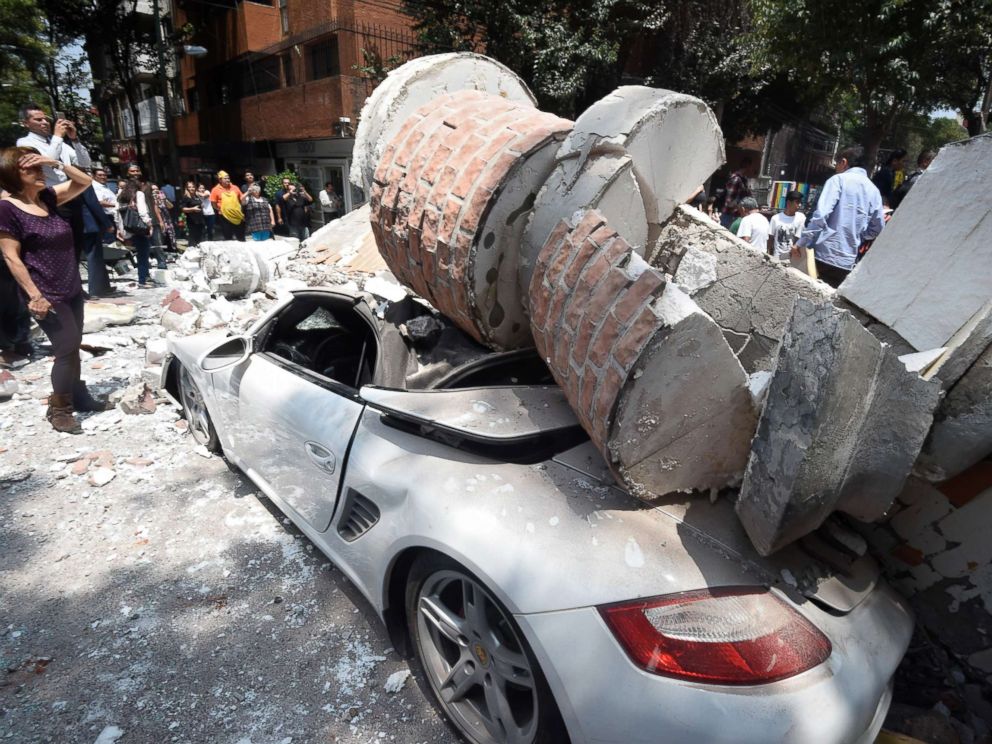 PHOTO: A car parked on the street in Mexico City sits under debris from a damaged building after a 7.1 earthquake rattled Mexico City on September 19, 2017.