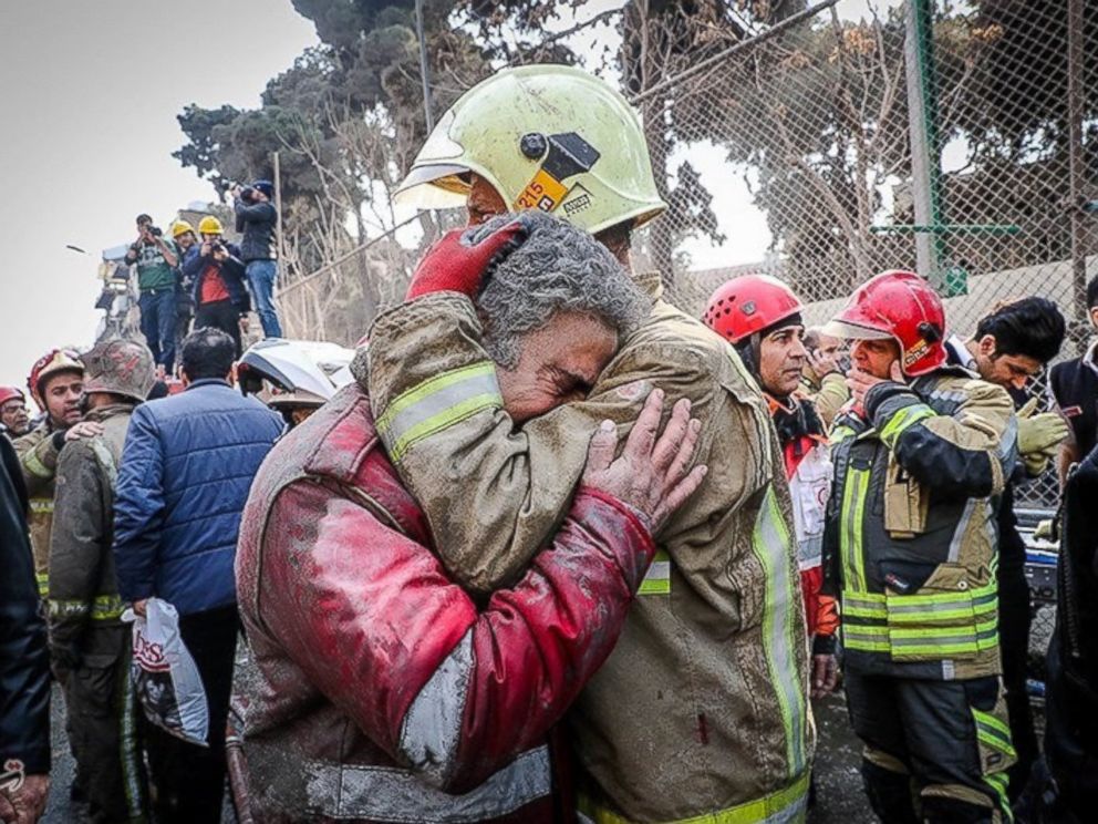 PHOTO: Firefighters react at the site of a collapsed high-rise building in Tehran, Iran Jan. 19, 2017.