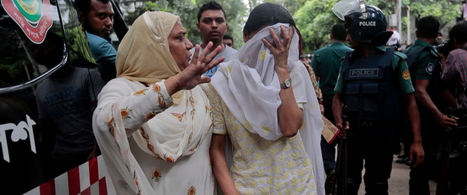 PHOTO: A relative tries to console Bangladeshi woman Semin Rahman, center, whose son is missing after militants took hostages in a restaurant popular with foreigners in Dhaka, Bangladesh, Saturday, July 2, 2016. 