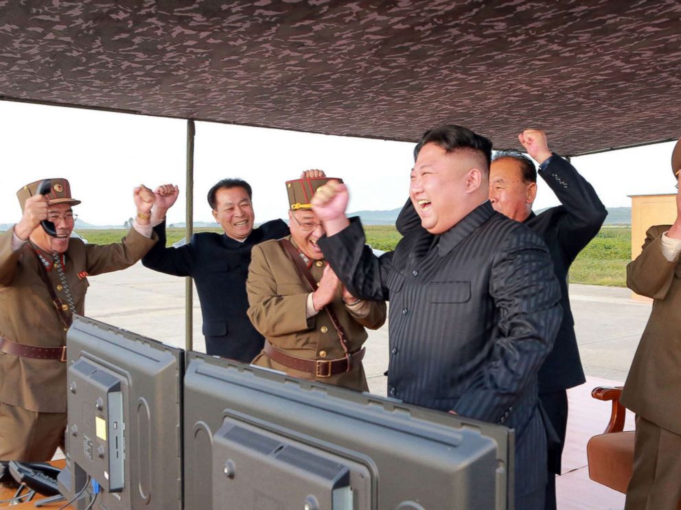 PHOTO: In this undated photo distributed on Sept. 16, 2017, by the North Korean government, leader Kim Jong Un, center, celebrates what was said to be the test launch of an intermediate range Hwasong-12 missile at an undisclosed location in North Korea.