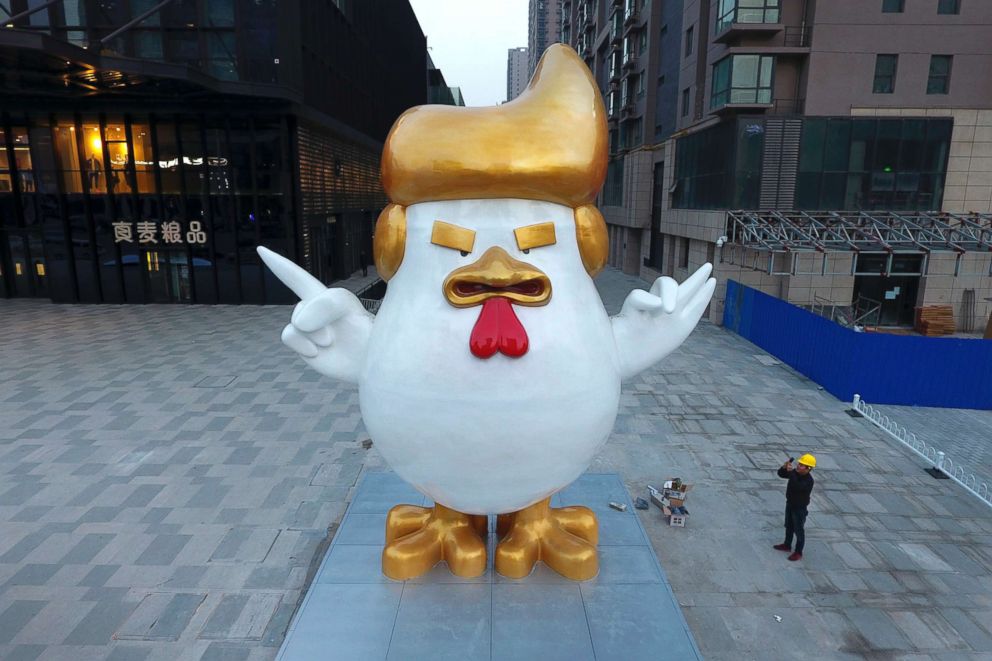 PHOTO: A worker takes a picture of a giant rooster sculpture resembling U.S. President-elect Donald Trump on display outside a shopping mall to celebrate the upcoming Chinese Year of the Rooster, Dec. 29, 2016, in Taiyuan in north Chinas Shanxi province.