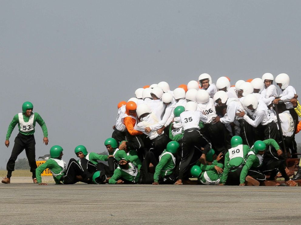 PHOTO:Members of the Army Service Corps motorcycle display team fall off and fail in a first attempt to break a World Record at the Air Force Station Yelahanka, in Bangalore, India, Nov. 19, 2017.