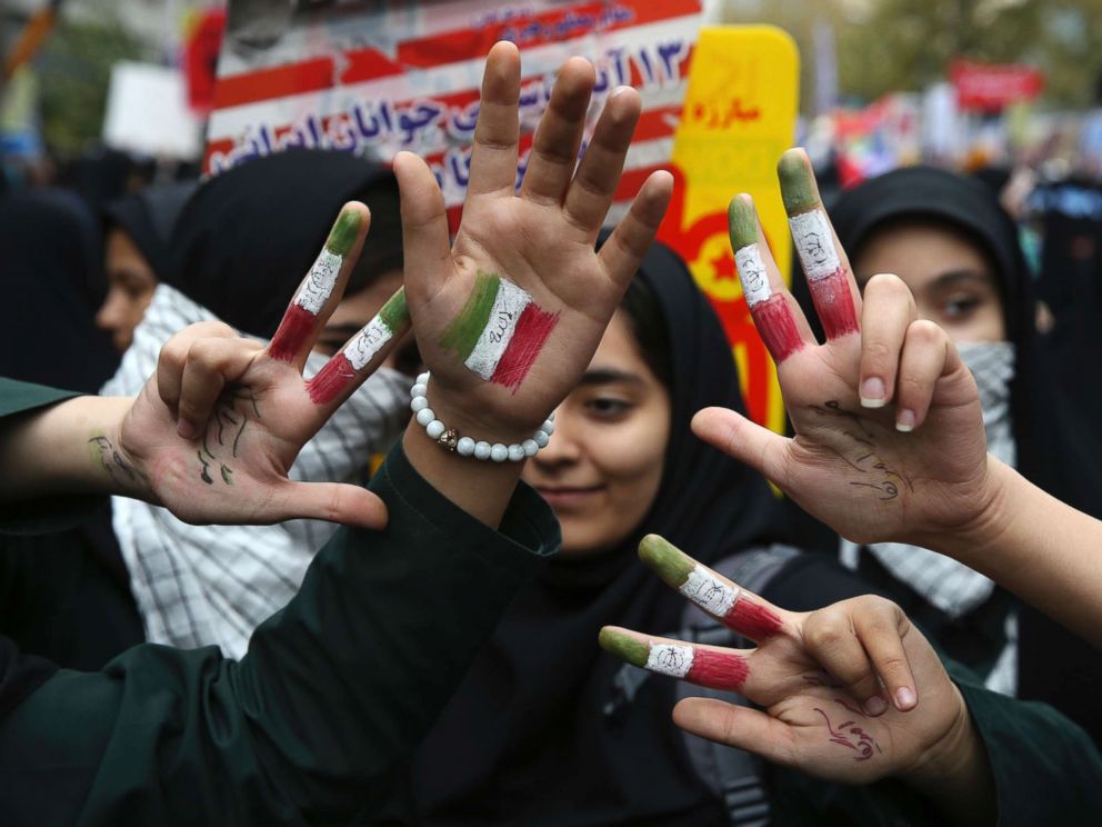 PHOTO: Iranian schoolgirls hold up their hands painted with the colors of their countrys flag and writing in Persian which reads, Death to America, in Tehran, Iran, Nov. 4, 2017. 