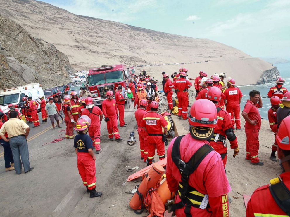 PHOTO: A picture released by Peruvian agency Andina shows firefighters and rescuers working during rescue efforts after a bus plunged over a cliff after colliding with a truck on a coastal highway near Pasamayo, on Jan. 2, 2018.