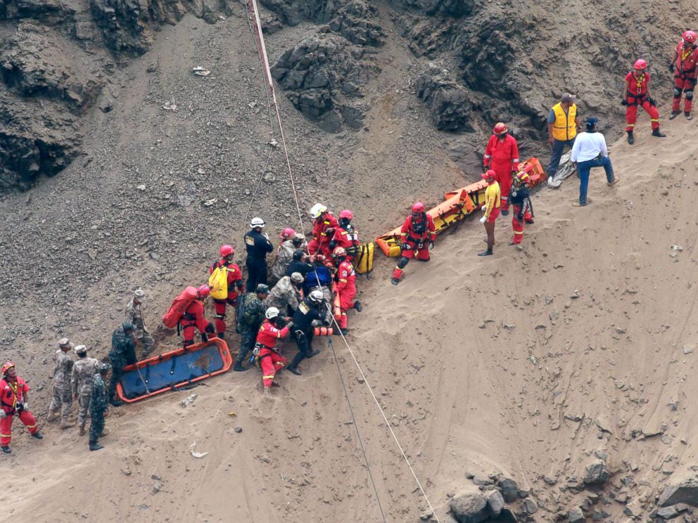 PHOTO: Rescue workers surround an injured man on a stretcher who was lifted up from the site of a bus crash at the bottom of a cliff in Pasamayo, Peru, Jan. 2, 2018.