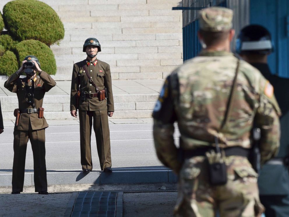 PHOTO: North Korean soldiers, left, look toward the South side while U.S. Defense Secretary Jim Mattis and South Korean Defense Minister Song Young-moo visit the truce village of Panmunjom on the border between North and South Korea, Oct. 27, 2017.