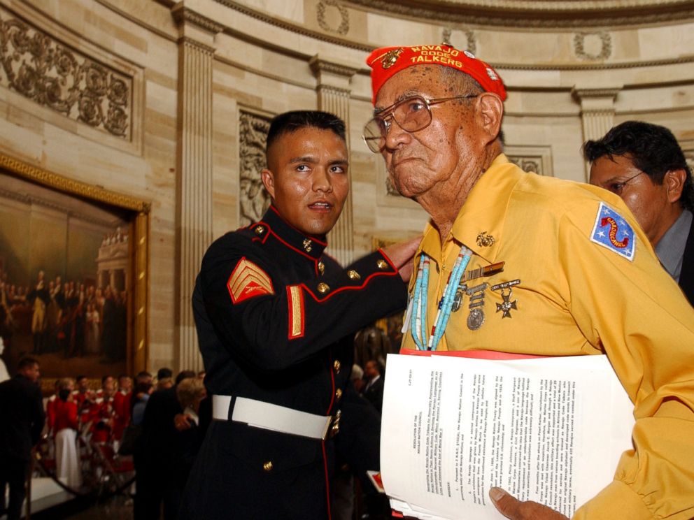   PHOTO: John Brown, Jr., Navajo Code Talker, gets a pat on the back of a young Marine after receiving the Gold Medal from Congress at the Capitol in Washington, DC 