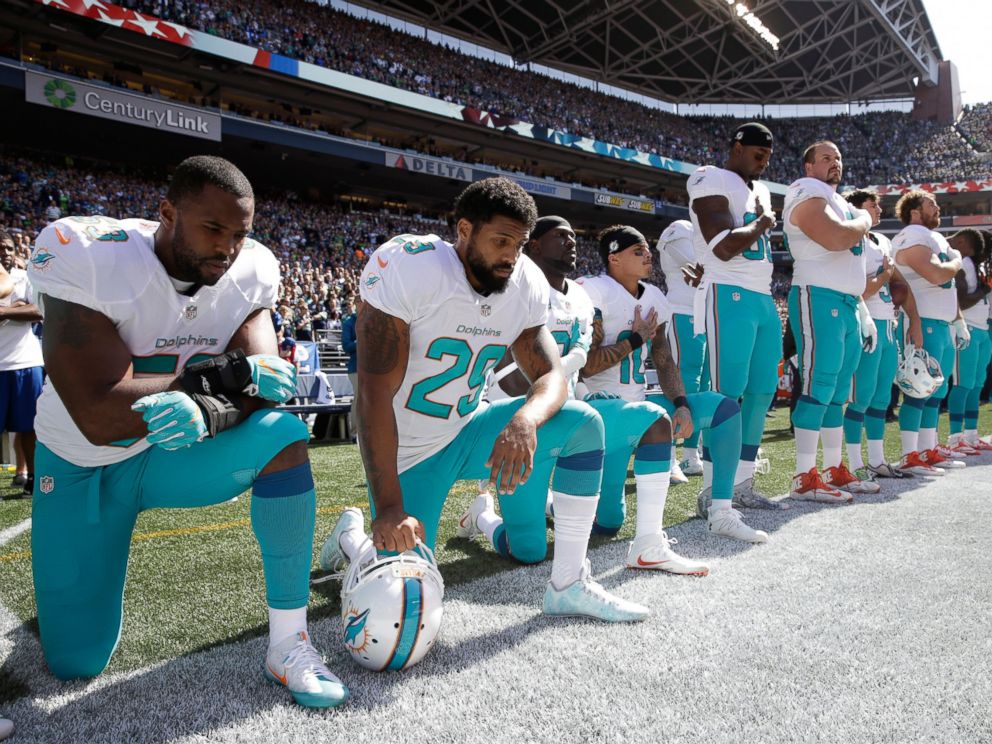 PHOTO: From left, Miami Dolphins Jelani Jenkins, Arian Foster, Michael Thomas, and Kenny Stills, kneel during the singing of the national anthem before an NFL football game against the Seattle Seahawks, Sept. 11, 2016, in Seattle.