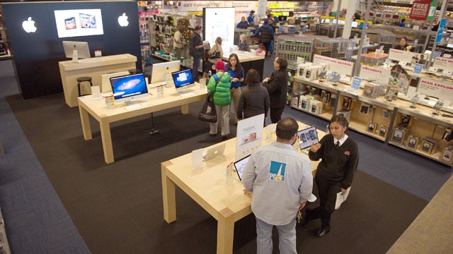 PHOTO: Customers look at Apple Inc. products at a Best Buy Co. store in San Francisco, Dec. 9, 2011.