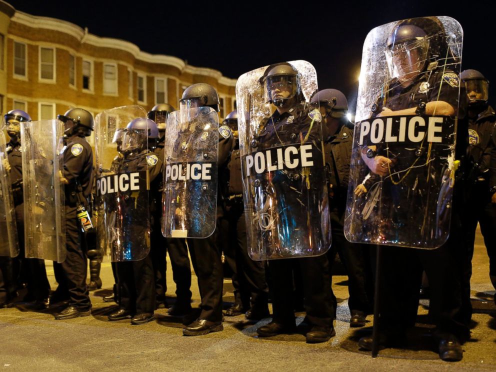 Police stand in formation as a curfew approaches, Tuesday, April 28, 2015, in Baltimore, a day after unrest that occurred following Freddie Grays funeral.