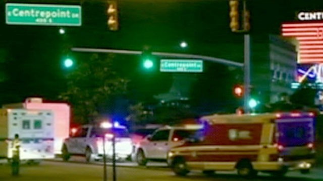 PHOTO: Police rush to the scene after a shooting at a movie theater in Aurora, Colo. on Friday, July 20, 2012.