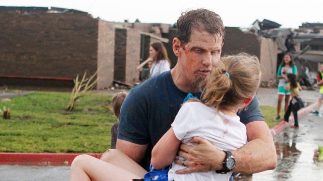 PHOTO: Teachers carry children away from Briarwood Elementary school after a tornado destroyed the school in south Oklahoma City, May 20, 2013.