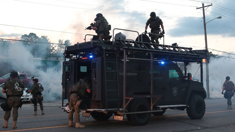 PHOTO: Tactical officers fire tear gas on Monday, Aug. 11, 2014, in Ferguson, Mo.