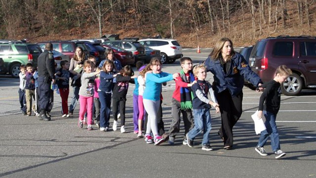 PHOTO: State police personnel led children from the school, following a shooting at Sandy Hook Elementary, Dec. 14, 2012.