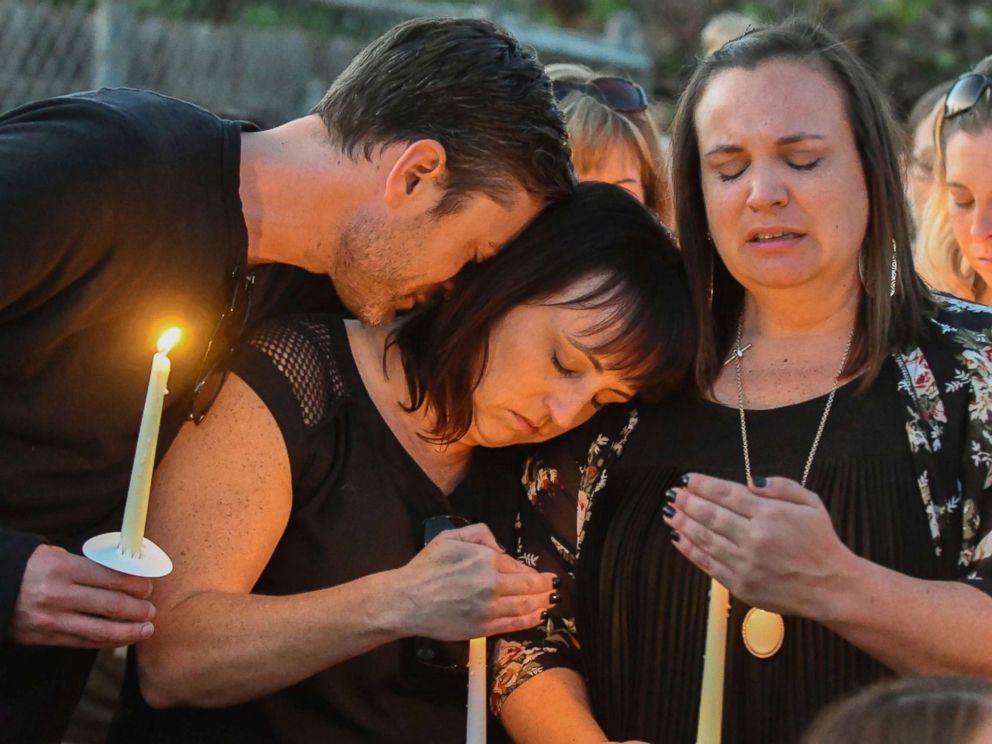 PHOTO: Ryan DiDonato, left, lays his head on Heather Gyurina, center, and Tracy Gyurina, right, during a candlelight vigil for their friend Teresa Nicol Kimura at Sierra Vista Elementary in Placentia, Calif., Oct. 8, 2017. 